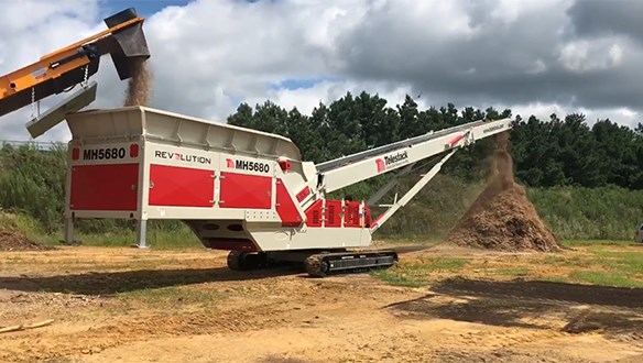 MH5680 stockpiling mulch from primary grinder